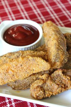 baked potato logs on a plate with ketchup and dipping sauce in the background