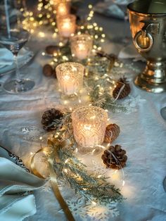 a table with candles and pine cones on it