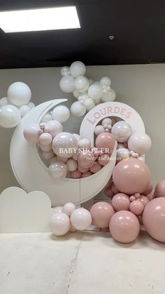 some balloons are laying on the floor in front of a sign that says baby shower