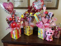 a table topped with lots of candy and valentine's day decorations on top of it