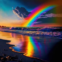 a rainbow is reflected in the water on a beach with waves coming in to shore