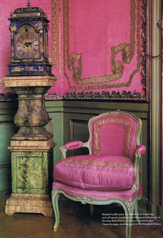 a pink chair sitting next to a tall clock