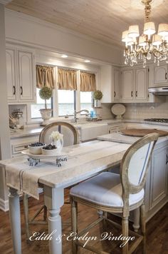 a kitchen with white cabinets and an island in front of the stove top is shown