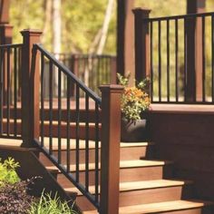 a wooden deck with railing and planters on it