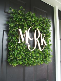 a door with a wreath and monogrammed letters on it