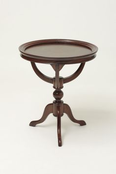 a small wooden table with a glass top