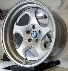 a silver wheel is on display in a showroom