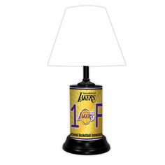 a lamp that is sitting on top of a white tablecloth with the number one lakers logo