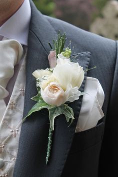 a man in a suit with a boutonniere on his lapel