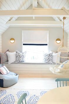 a living room filled with lots of furniture next to a white ceiling mounted window sill