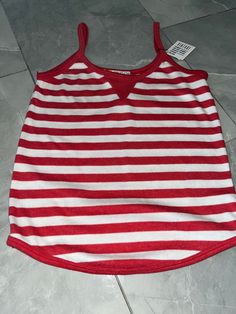 "Vintage red and white striped tank made by Clothes To You. 65% polyester, 35% cotton. Tagged as a medium, measures 13\" pit to pit, 20\" long." Spring Sleeveless Tank Top With Contrast Stripes, Red Cotton Top With Vertical Stripes, Red Cotton Tops With Vertical Stripes, Striped Racerback Tops For Spring, Sleeveless Cotton Tank Top With Contrast Stripes, Cotton Sleeveless Tank Top With Contrast Stripes, Sleeveless Tank Top With Contrast Stripes For Summer, Summer Sleeveless Tank Top With Contrast Stripes, Sleeveless Summer Tank Top With Contrast Stripes