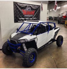 a white and blue dune buggy parked in a garage