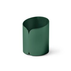 a green vase sitting on top of a white surface