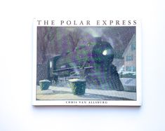 the polar express book is sitting on top of a white wall with snow falling from it