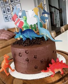 a chocolate cake with dinosaur decorations on top