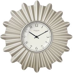 a white clock with black hands and numbers on it's face is shown in the shape of a sunburst