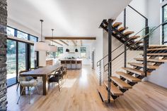 a living room filled with furniture next to a wooden floor covered in hard wood stairs