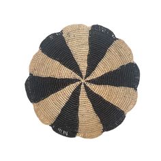 a black and white basket with stripes on it's sides, in the shape of a circle