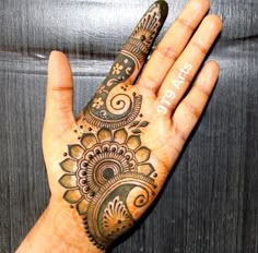 a person's hand with henna tattoos on it