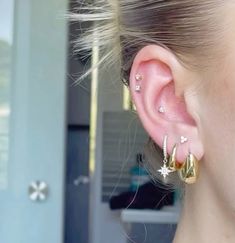 a close up of a person with ear piercings