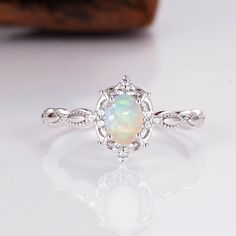 Gorgeous vintage inspired Australian opal ring ✧ Sterling silver (925) or 14K Gold or 14K Rose gold ✧ Accented with natural quartz diamonds This gorgeous, timeless ring features a stunning Australian opal and natural crystals. ✧ Stone: Natural Gemstone  ✧ Shape: Oval ✧ Carat Weight: 0.53ct. (approx.) ✧ Gemstone Origin: Australia  ✧ Sizes 2.75-12.25 ✧ This ring set will arrive ready to gift in a Kherish Box. ✧ Due to the nature of the handmade process, each piece may slightly vary in color, size, Elegant Ethiopian Opal Ring For Anniversary, Opal Birthstone Ring In White Gold For Gift, Elegant Ethiopian Opal Ring For Gifting, Elegant Ethiopian Opal Ring Gift, Silver Oval Opal Ring In 14k Gold, Delicate Sterling Silver Opal Ring, Silver Opal Ring In 14k Gold With Oval Shape, White Gold Opal Ring As A Gift, Oval Opal Ring In 14k Gold