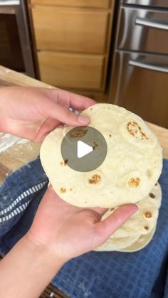 a person holding a tortilla in their hand