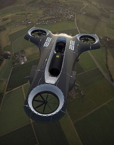 an airplane flying over a lush green countryside