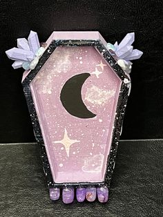 a pink and black box with purple decorations on it