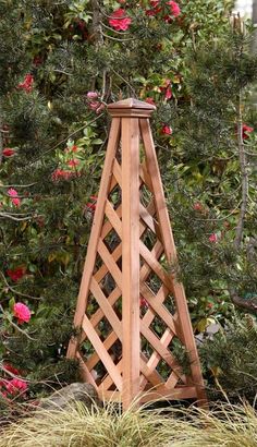 a wooden tower in the middle of some flowers