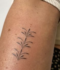 a woman's arm with a small tattoo design on the left side of her body