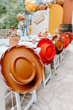 there are many hats lined up on the tables