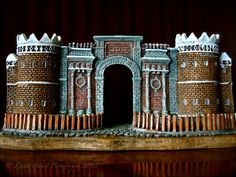 a model of a castle made out of brick and stone with an arched doorway on top