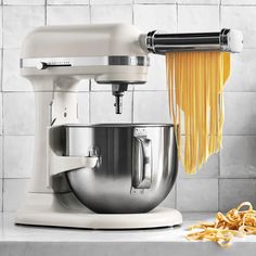 a white mixer and some pasta on a counter