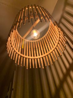 a wooden light fixture hanging from the ceiling