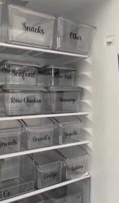 an organized pantry with clear bins and labels