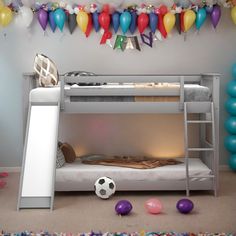 a bunk bed with a soccer ball on the floor next to balloons and streamers