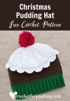 a crocheted christmas pudding hat with a pom - pom on top