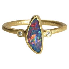 Striking, 1.08ct Freeform Australian Boulder Opal Ring with Diamonds, 24K Yellow, Solid Gold. One of a Kind Ring. This piece would make a great stacker ring with other dainty pieces paired next to it.   The opal rings in the gallery could also make incredible bridesmaids gifts. Find more exquisite, high quality, opal jewelry in the gallery Details: Diamonds: 0.02ct Opal: 1.08ct.  This opal is one of a kind making this ring, one of a kind. Size: 7 (US) Total weight: 3.35 grams About Opal: In anci The Gift Of Prophecy, Boulder Opal Ring, Big Jewelry, Australian Boulder Opal, Opal Ring, Boulder Opal, October Birth Stone, Opal Jewelry, Bridesmaids Gifts