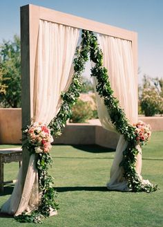 an outdoor wedding setup with flowers and greenery