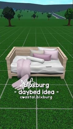 a couch sitting on top of a lush green field next to a wooden box filled with pillows