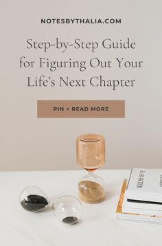 a white table topped with glasses next to a book