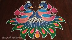 colorful peacocks painted on the floor in front of a wooden table with white writing