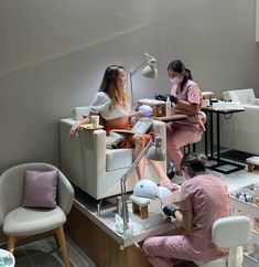 three women sitting in chairs around a table