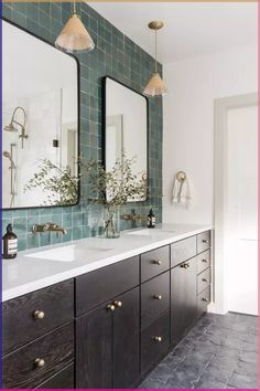 a bathroom with two sinks and mirrors in it