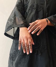 a woman with henna tattoos on her hands