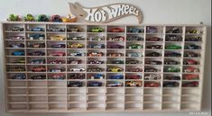 there is a toy shelf with many cars on it