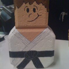 a paper mache with a man's face on it and a black belt around his waist