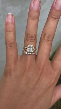 a woman's hand with a ring on it and a diamond in the middle