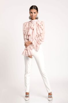 "Transport yourself to an era of timeless elegance with our exquisite light pink formal chiffon designer shirt. Inspired by the grace and sophistication of the Victorian era, this shirt is a masterpiece of design, blending vintage charm with modern style. Whether you're attending a formal event, a romantic soirée, or simply want to channel your inner royalty, this shirt is your passport to a world of refined fashion. Features: 🌸 Victorian Aesthetic: This shirt embodies the opulence and intricate detailing of the Victorian era. From the high neckline to the delicate lace cuffs, every element of this design pays homage to a bygone era of refinement. 💃 Chiffon Elegance: Crafted from the finest chiffon fabric, this shirt drapes gracefully, creating a sense of ethereal beauty as you move. The Elegant Chiffon Blouse With Ruffled Collar, Formal Fitted Chiffon Tops, Feminine Chiffon Top For Work, Spring Chiffon Blouse With Ruffled Collar, Workwear Chiffon Tie Neck Blouse, Long Sleeve Chiffon Wedding Top, Feminine Ruffled Chiffon Tops, Feminine Chiffon Tops With Ruffles, Elegant Pink Tie Neck Top