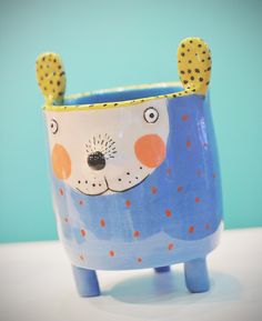 a blue and white ceramic animal planter with polka dots on it's ears